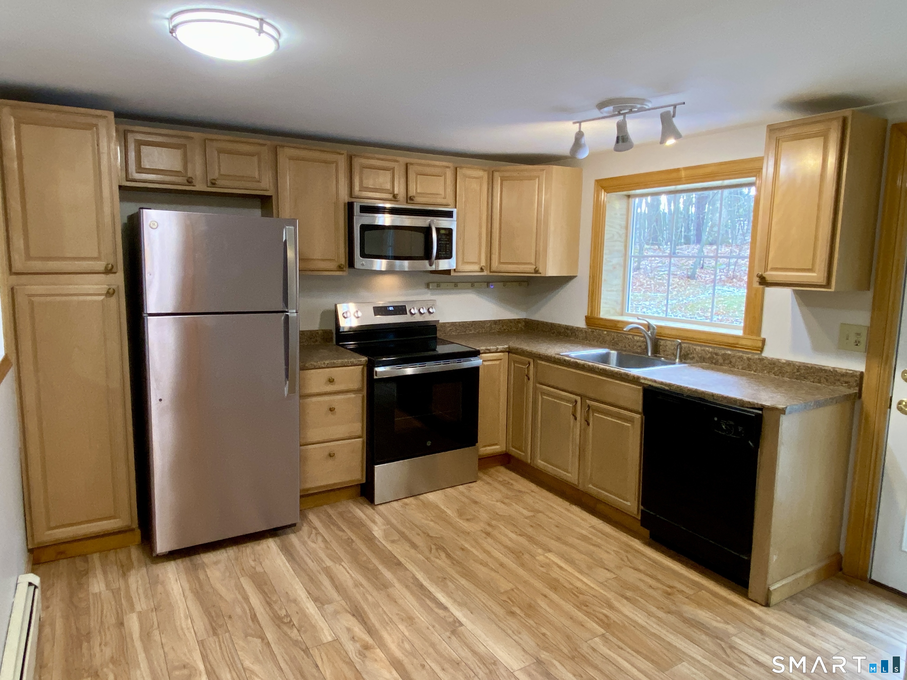 8 S Road Ellington, CT 06029 - Photo 7 of 21 a kitchen with stainless steel appliances granite countertop a refrigerator a sink dishwasher a stove top oven a refrigerator with island and chairs