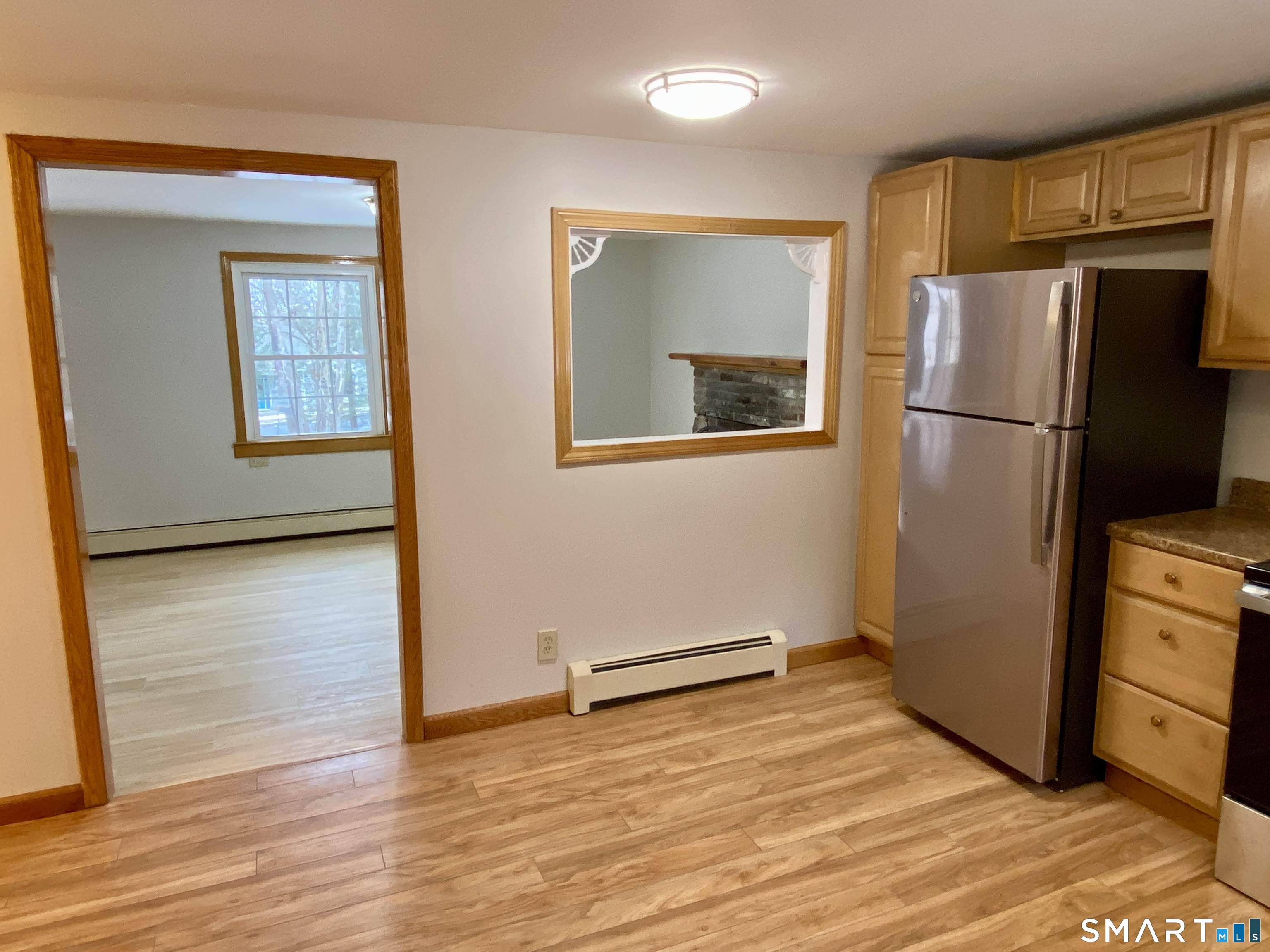 8 S Road Ellington, CT 06029 - Photo 9 of 21 a view of a kitchen with wooden floor and a refrigerator