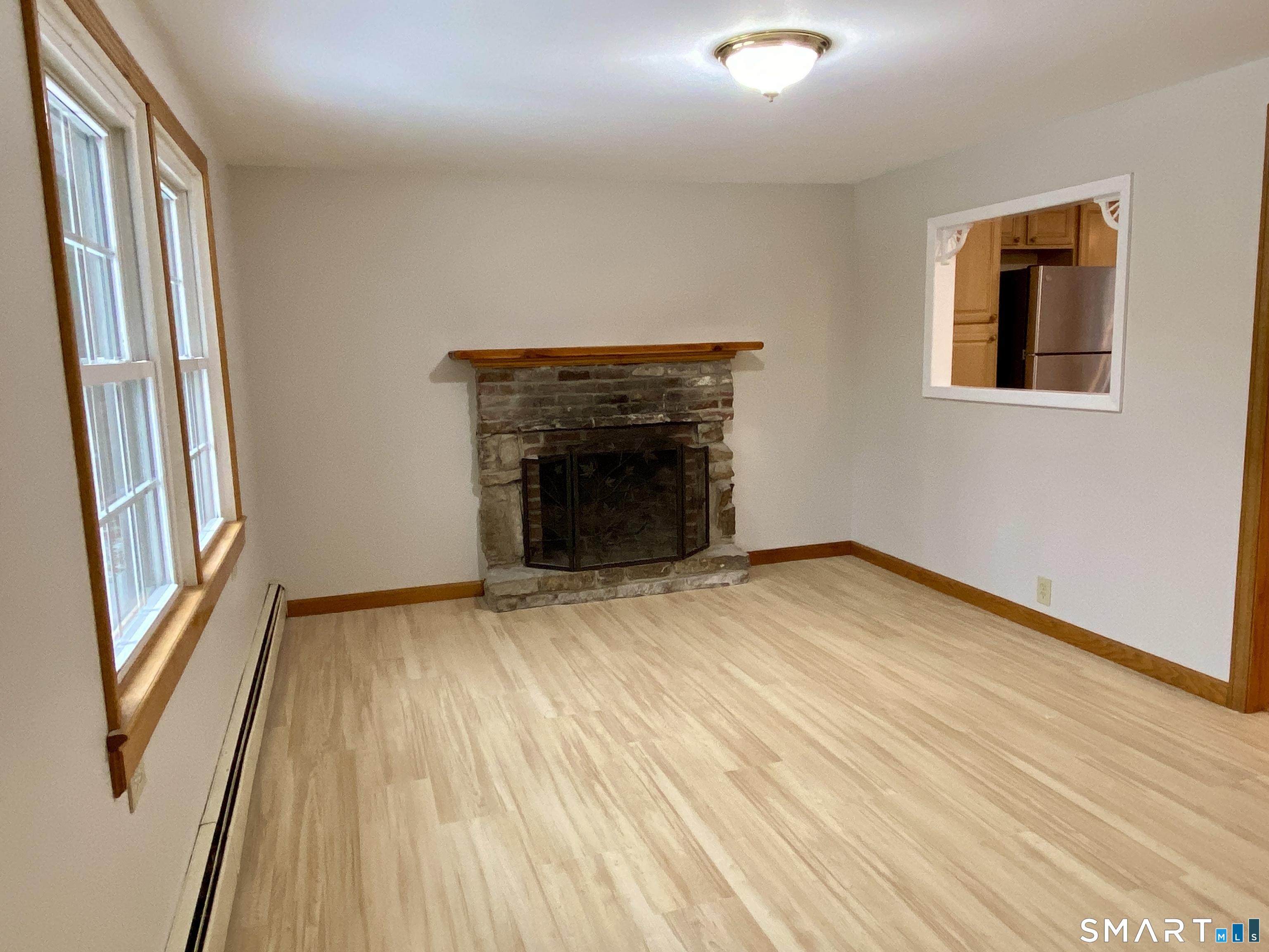 8 S Road Ellington, CT 06029 - Photo 10 of 21 a view of an empty room with wooden floor and a window