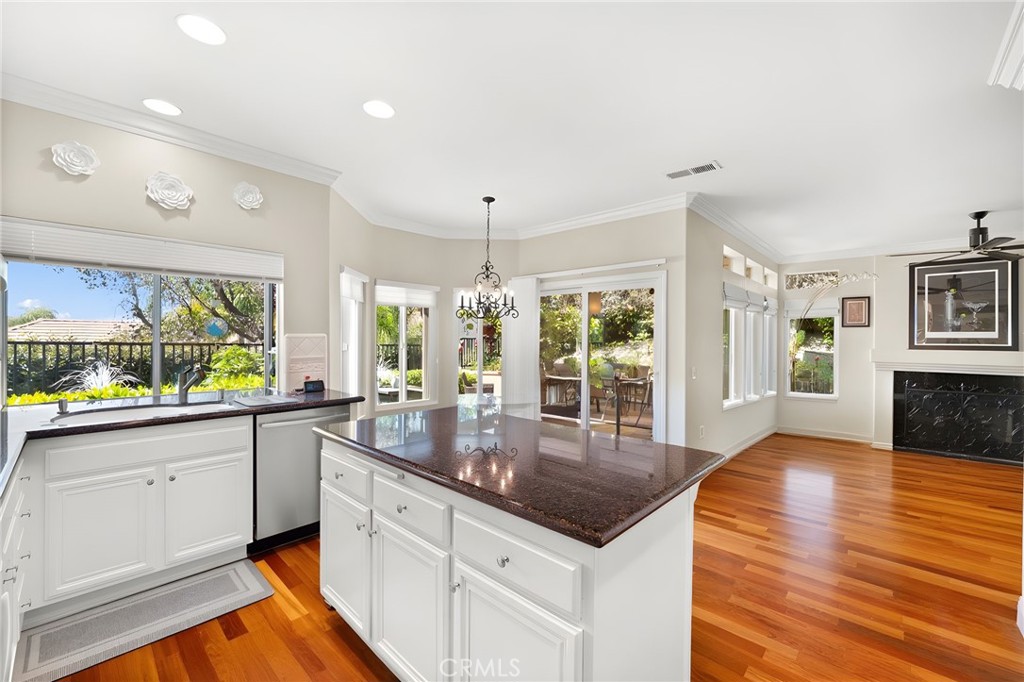 28561 Camelback Road Trabuco Canyon, CA 92679 - Photo 15 of 66 a kitchen with stainless steel appliances granite countertop a sink a stove and wooden floor