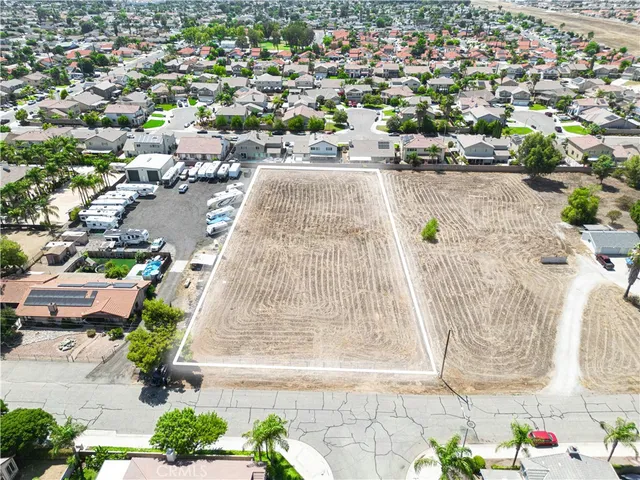 an aerial view of a swimming pool with outdoor seating