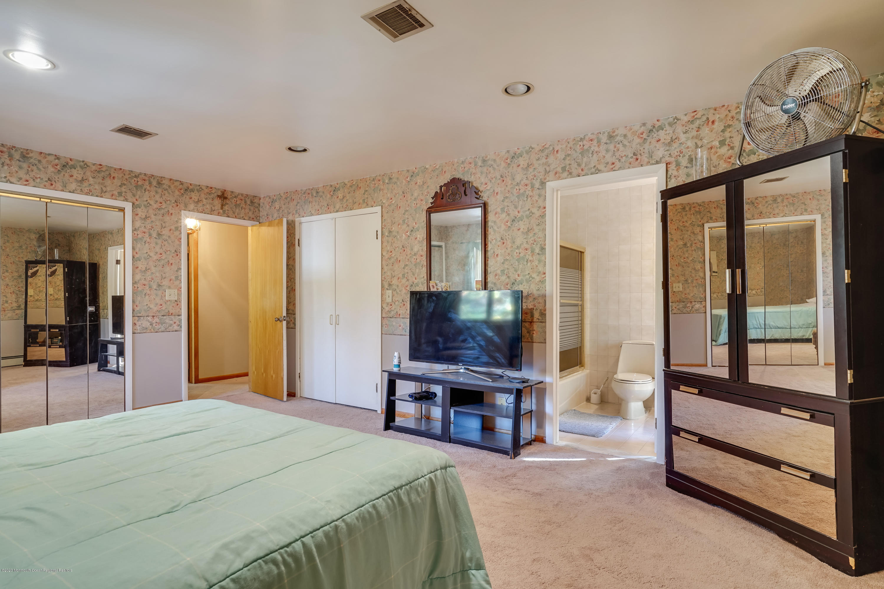 43 Korman Road Bayville, NJ 08721 - Photo 32 of 47 a bedroom with a bed and a flat tv screen on the dresser