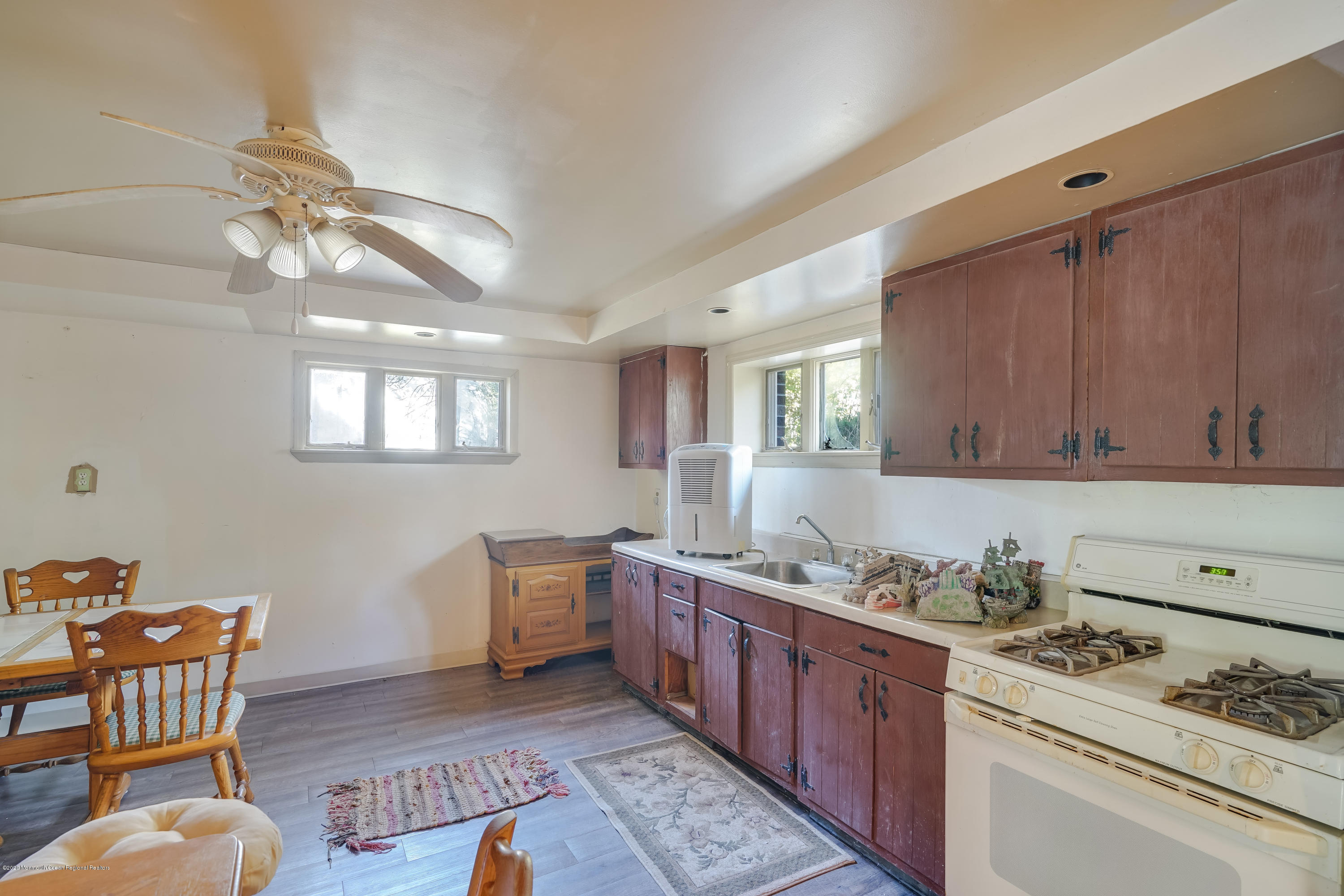 43 Korman Road Bayville, NJ 08721 - Photo 39 of 47 a kitchen with stainless steel appliances granite countertop a stove a sink dishwasher and cabinets with wooden floor