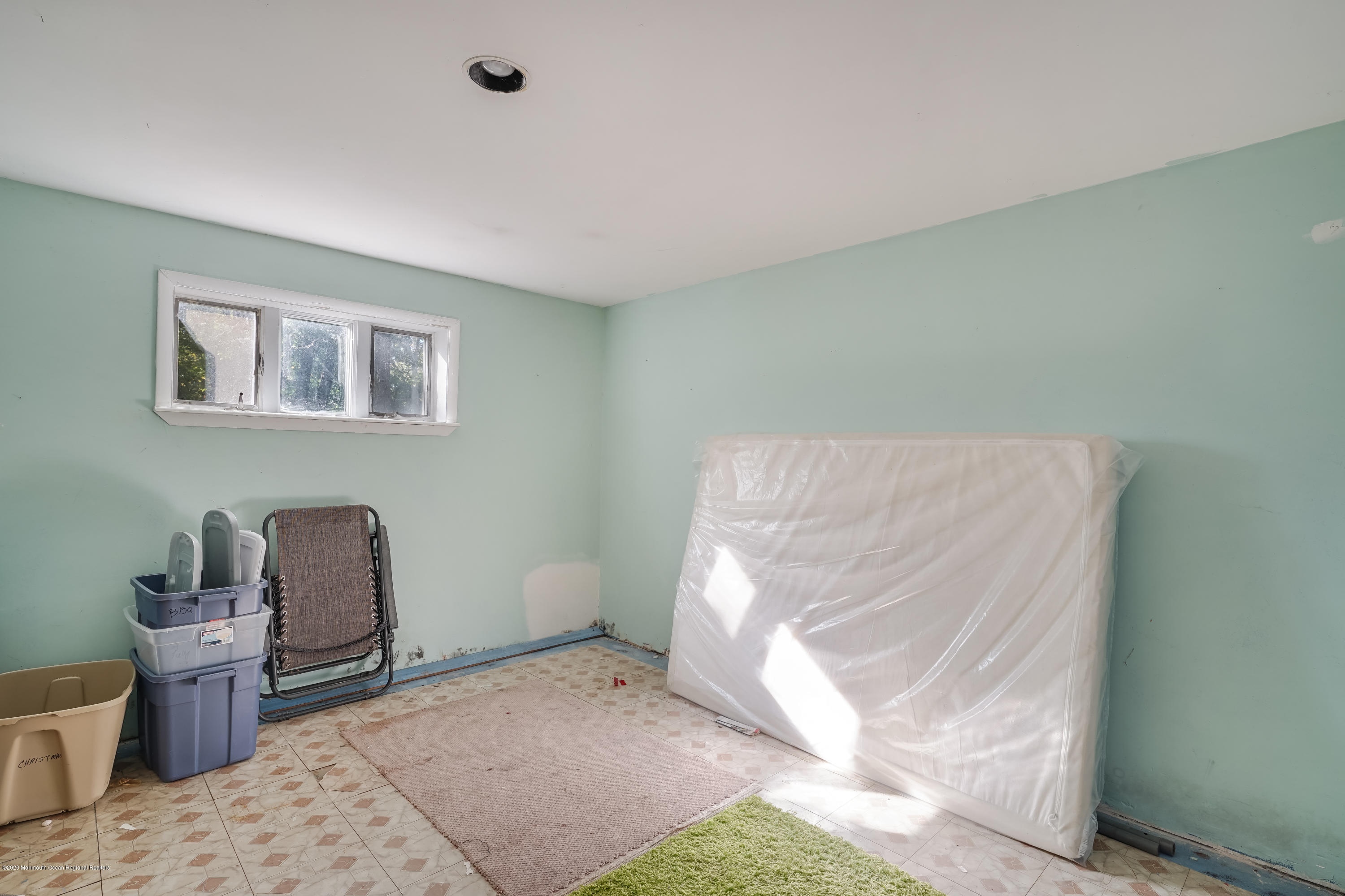 43 Korman Road Bayville, NJ 08721 - Photo 40 of 47 a bedroom with a bed and a chair