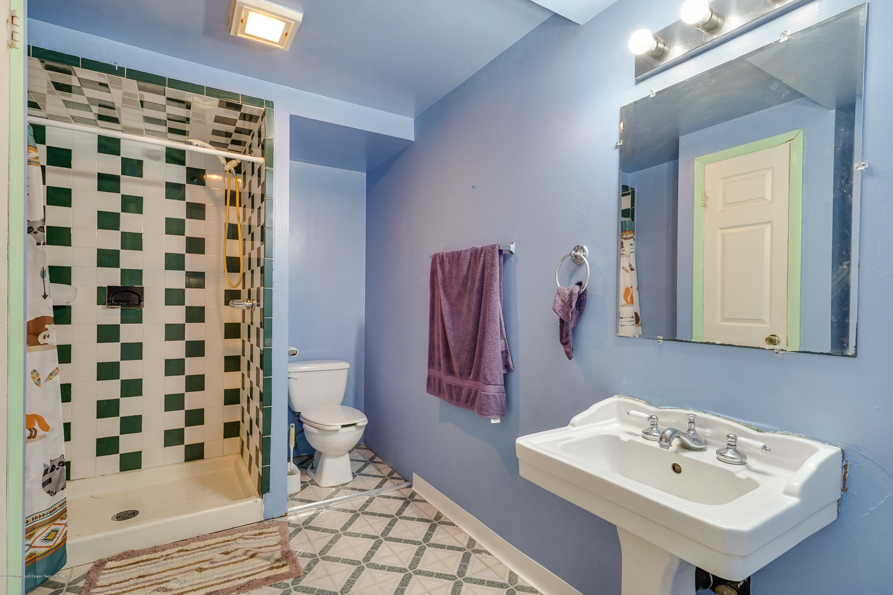 43 Korman Road Bayville, NJ 08721 - Photo 43 of 47 a bathroom with a sink a toilet and shower curtain