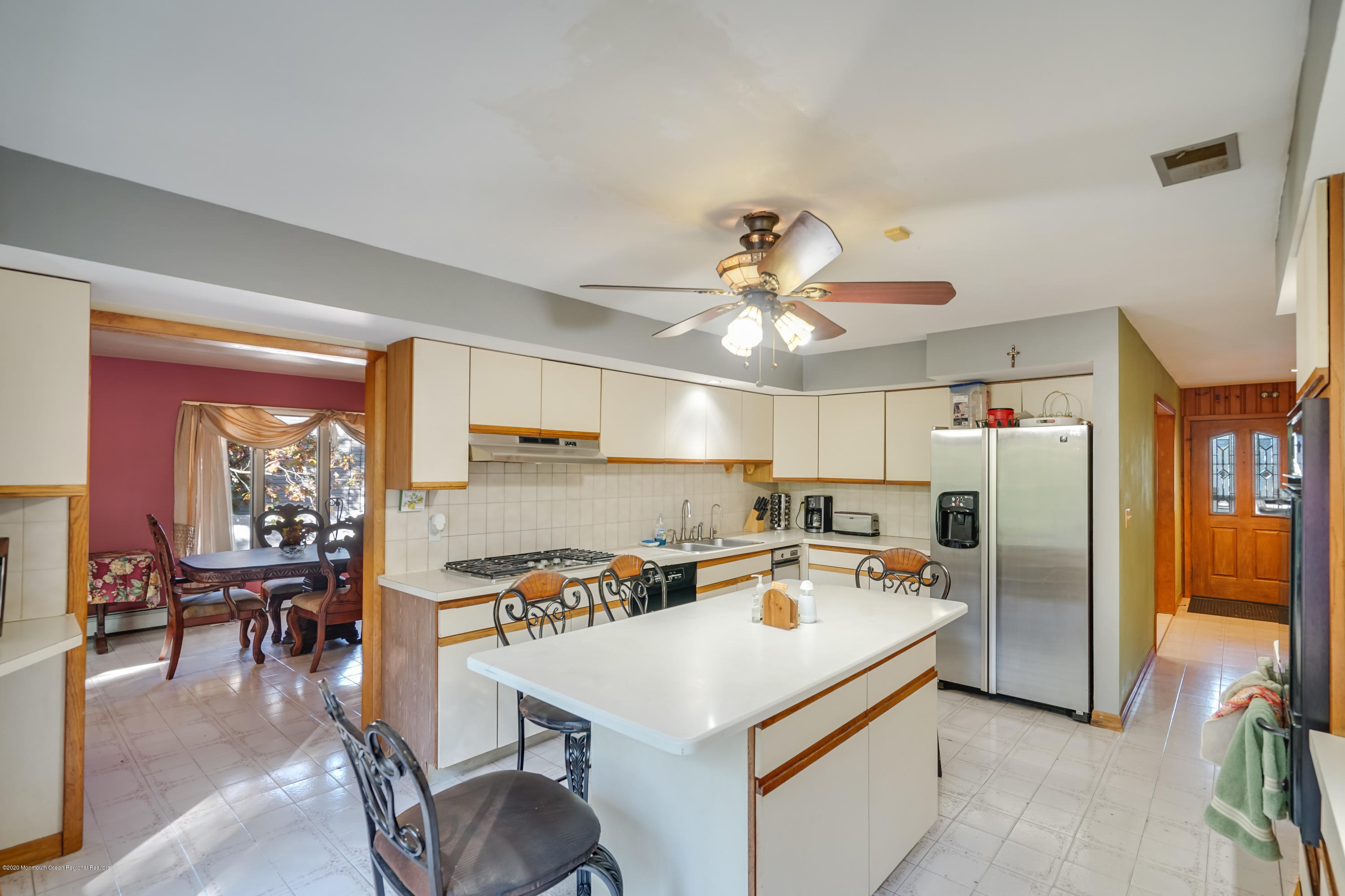 43 Korman Road Bayville, NJ 08721 - Photo 10 of 47 a kitchen with a refrigerator a stove a dining table and chairs with wooden floor