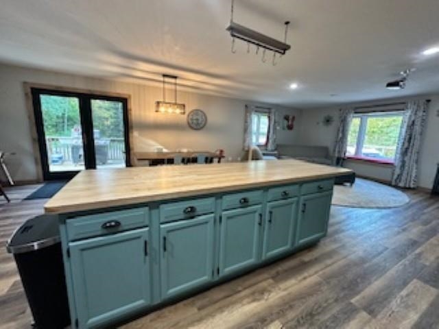 7345 Rahkola Road Embarrass, MN 55732 - Photo 56 of 57 Kitchen featuring dark wood-style floors, hanging light fixtures, a kitchen island, open floor plan, and blue cabinets
