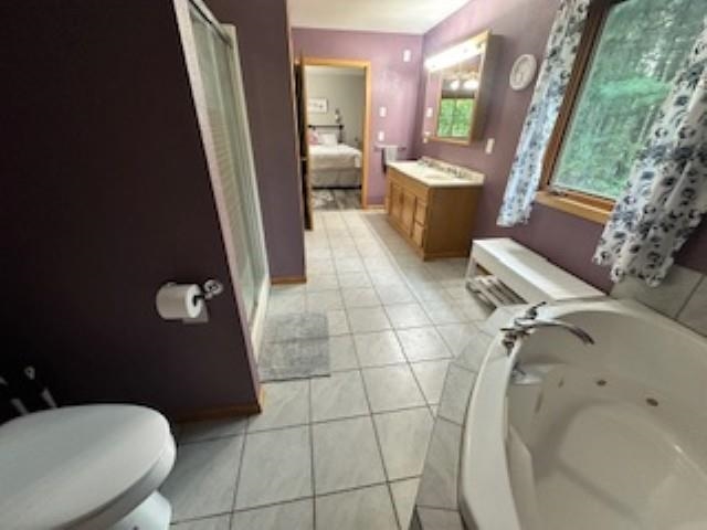 7345 Rahkola Road Embarrass, MN 55732 - Photo 30 of 57 Ensuite bathroom with vanity, a stall shower, a jetted tub, and light tile patterned floors