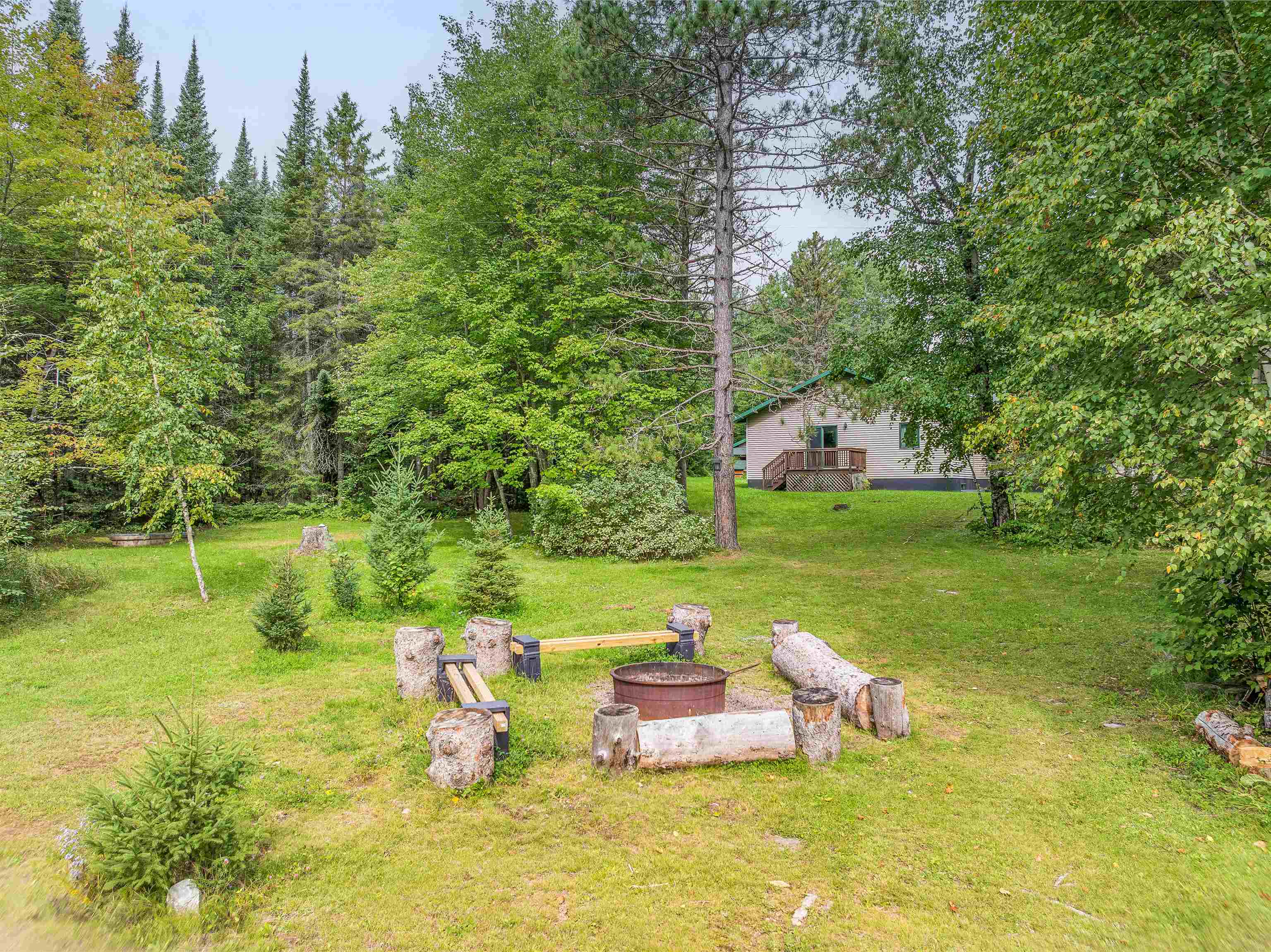 7345 Rahkola Road Embarrass, MN 55732 - Photo 33 of 57 View of green lawn with a fire pit