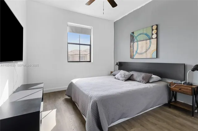 a bedroom with a bed and a flat screen tv