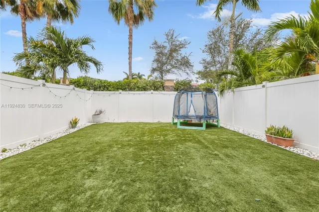 a view of backyard with outdoor seating and green space