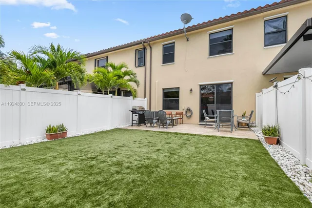a view of multiple houses with a yard