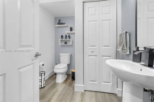 a bathroom with a sink a toilet and a mirror