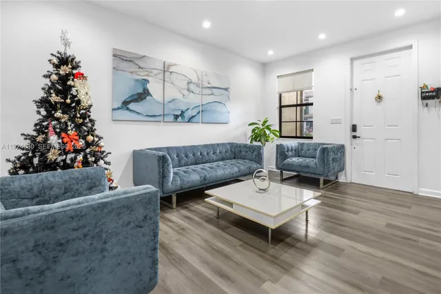 a living room with furniture and flowers