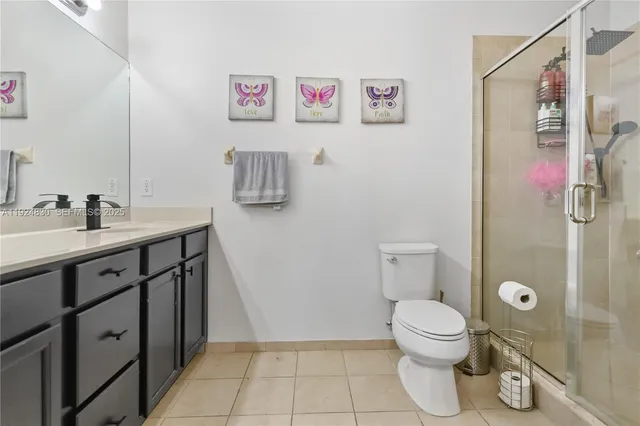 a bathroom with a sink mirror vanity and toilet