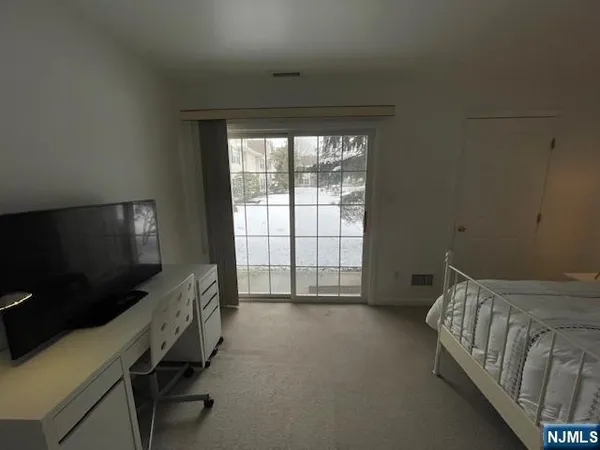 a spacious bedroom with a bed and a window