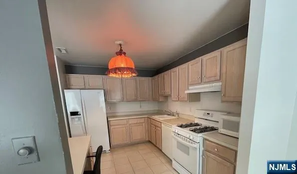 a kitchen with a refrigerator and a sink