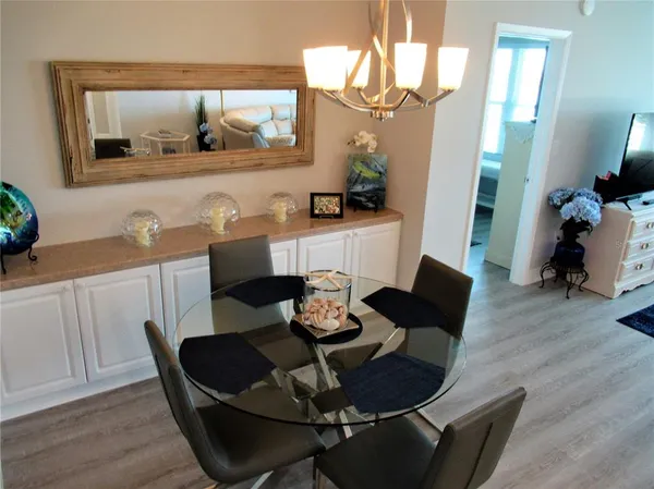 a living room with furniture and a painting on the wall