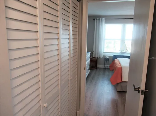 a hallway with a chair and a window