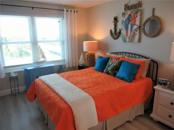 a bedroom with a bed and window