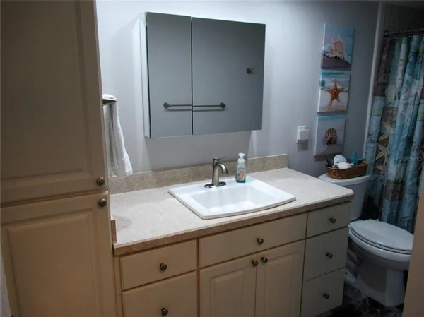 a bathroom with a sink toilet and vanity