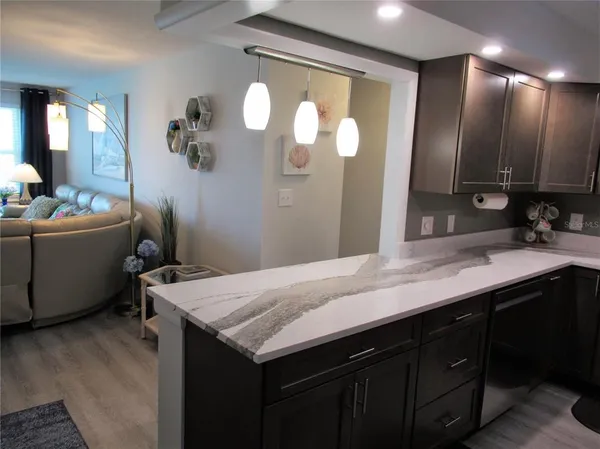 a bathroom with a granite countertop sink a toilet and mirror