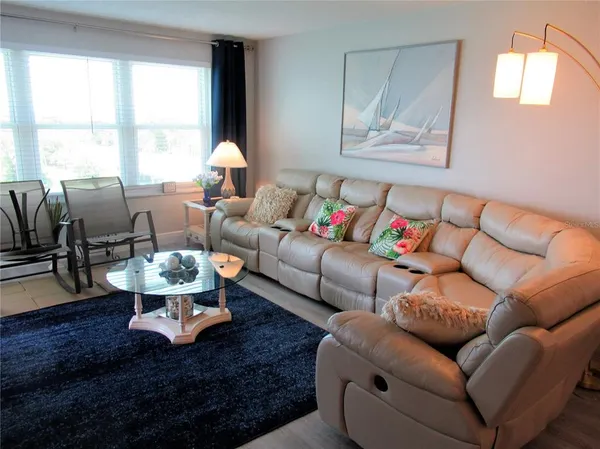 a living room with furniture or couch and a large window