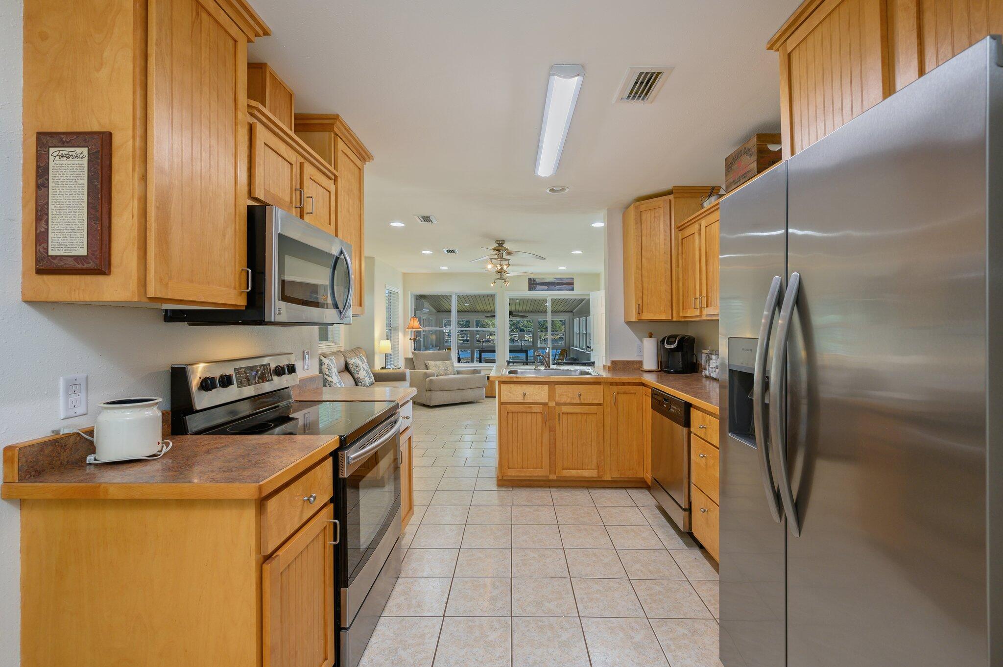 883 Squirrel Road DeFuniak Springs, FL 32433 - Photo 11 of 57 a kitchen with stainless steel appliances granite countertop a stove a sink and a refrigerator