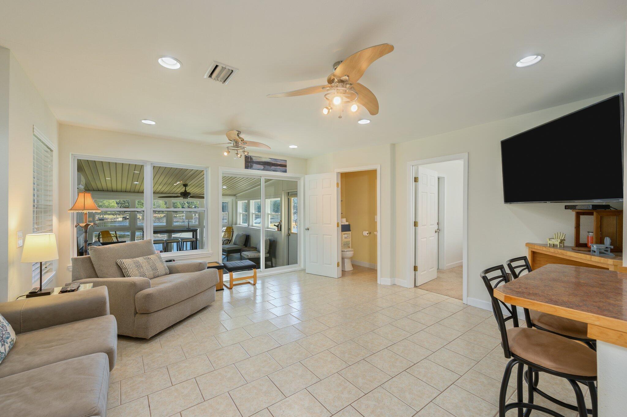 883 Squirrel Road DeFuniak Springs, FL 32433 - Photo 16 of 57 a living room with furniture and a flat screen tv
