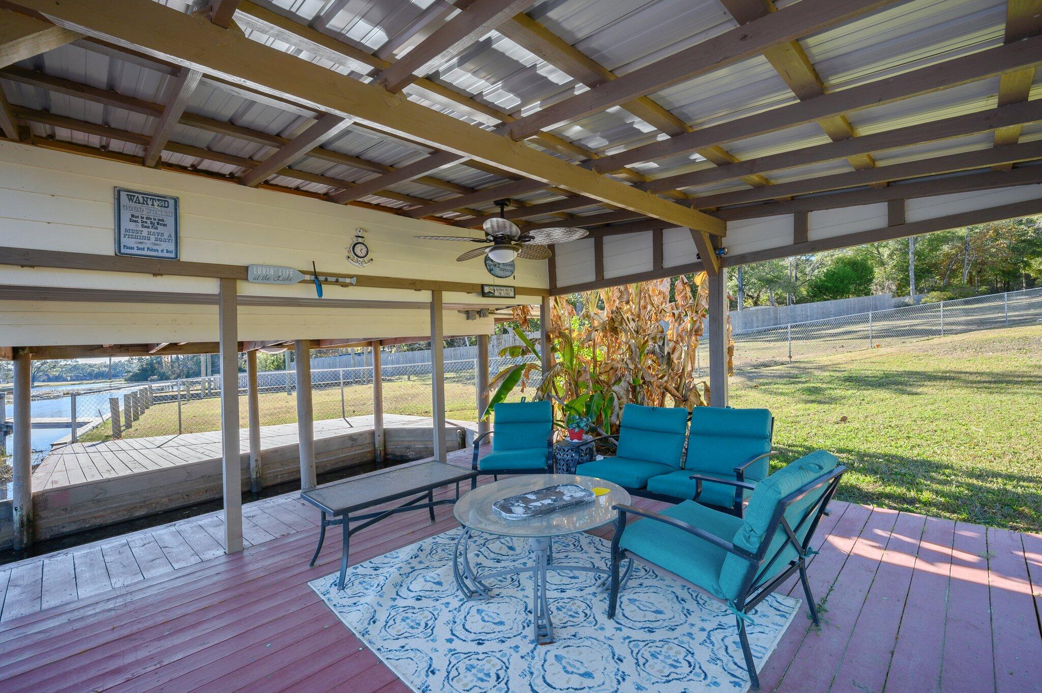 883 Squirrel Road DeFuniak Springs, FL 32433 - Photo 46 of 57 a balcony with couch and wooden floor