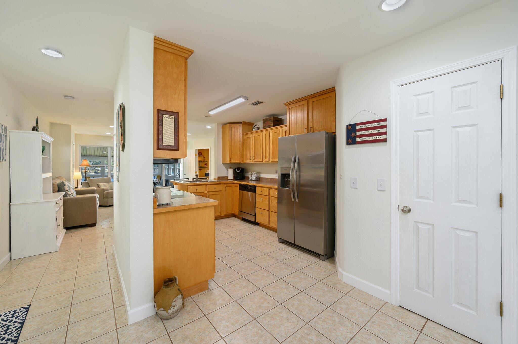 883 Squirrel Road DeFuniak Springs, FL 32433 - Photo 10 of 57 a kitchen with a refrigerator and white cabinets