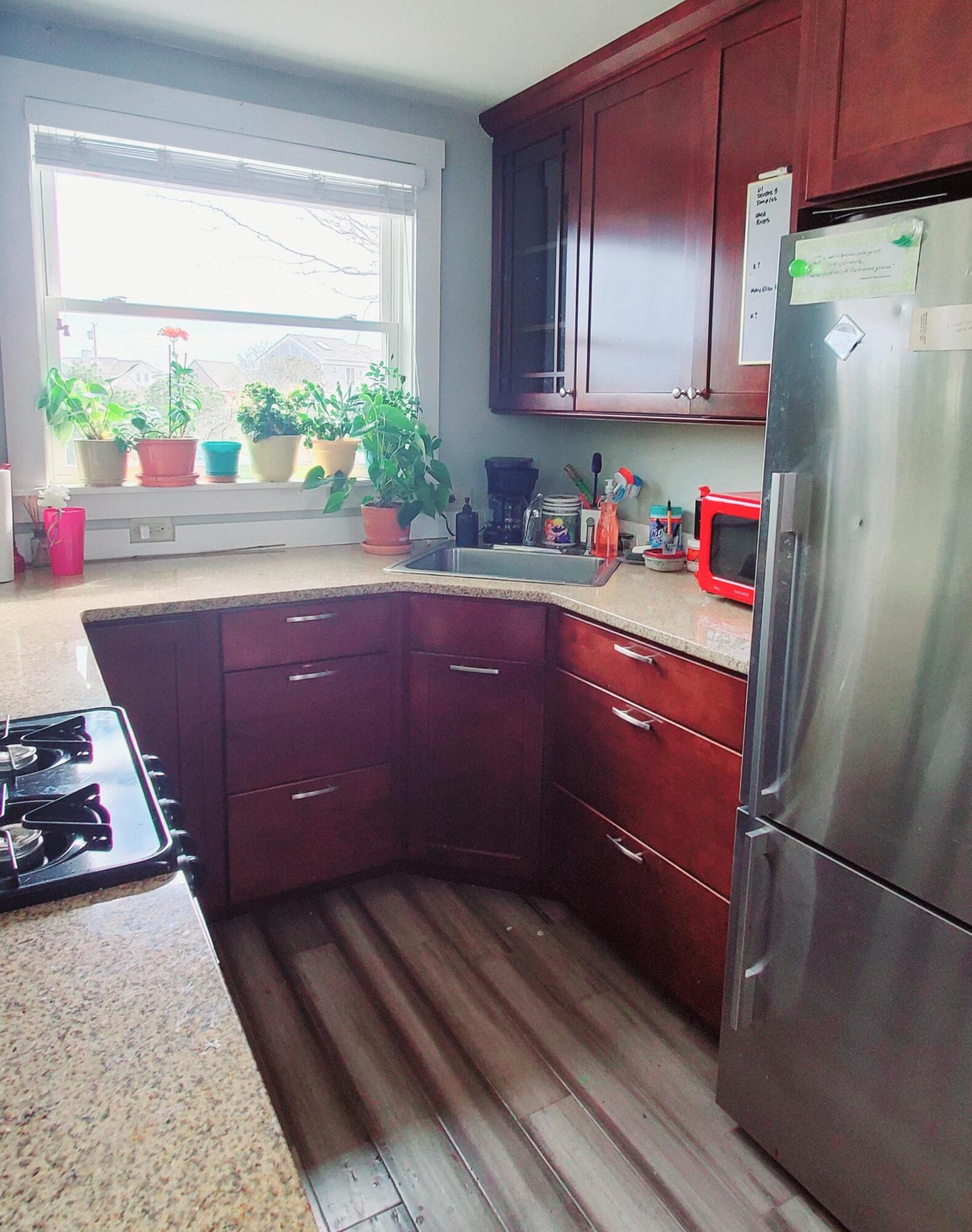 148 Shore Road, Unit 5 Truro, MA 02666 - Photo 3 of 17 a kitchen with stainless steel appliances granite countertop a refrigerator and a sink