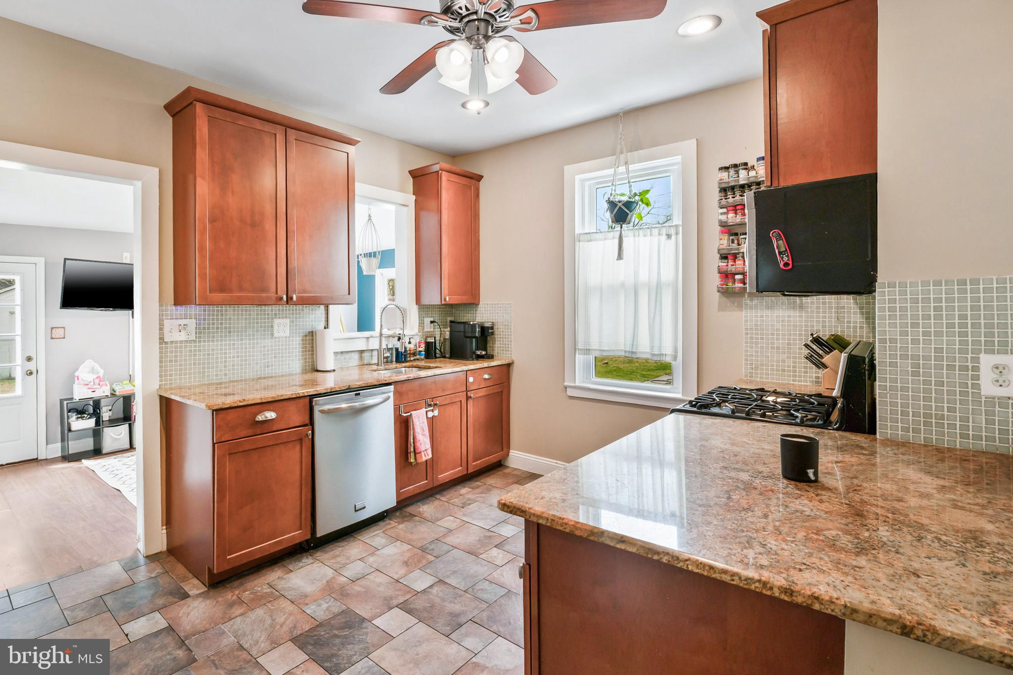 731 Washington Avenue Palmyra, NJ 08065 - Photo 11 of 40 a kitchen with stainless steel appliances granite countertop a sink dishwasher stove and refrigerator with wooden floor