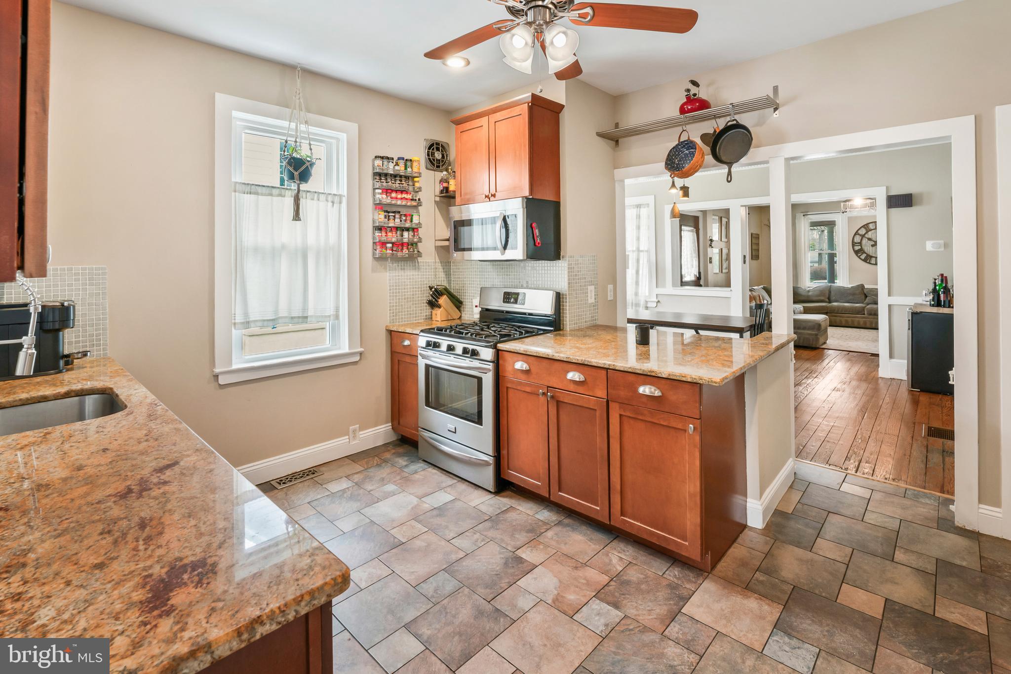 731 Washington Avenue Palmyra, NJ 08065 - Photo 12 of 40 a kitchen with stainless steel appliances granite countertop a stove a sink and a refrigerator