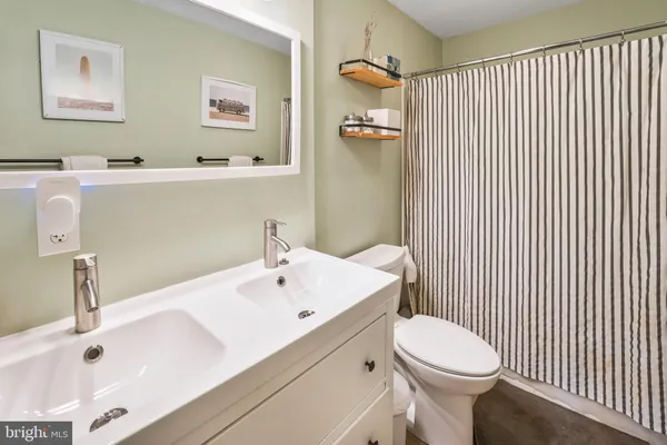 a bathroom with a sink a toilet and mirror
