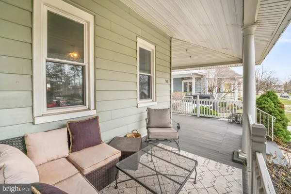 a balcony with furniture and potted plants