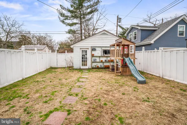 a view of a house with a wooden fence