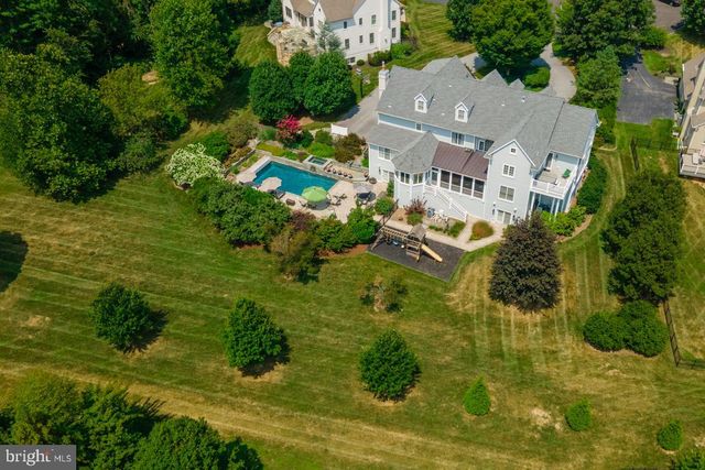 an aerial view of a house with yard swimming pool and outdoor seating