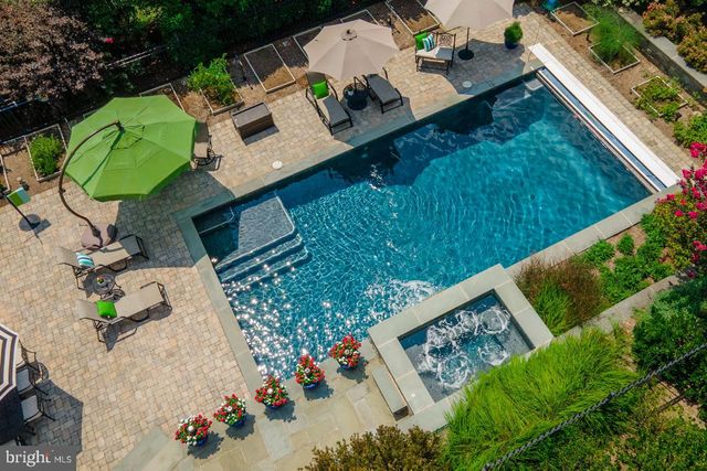 a view of a patio with table and chairs potted plants