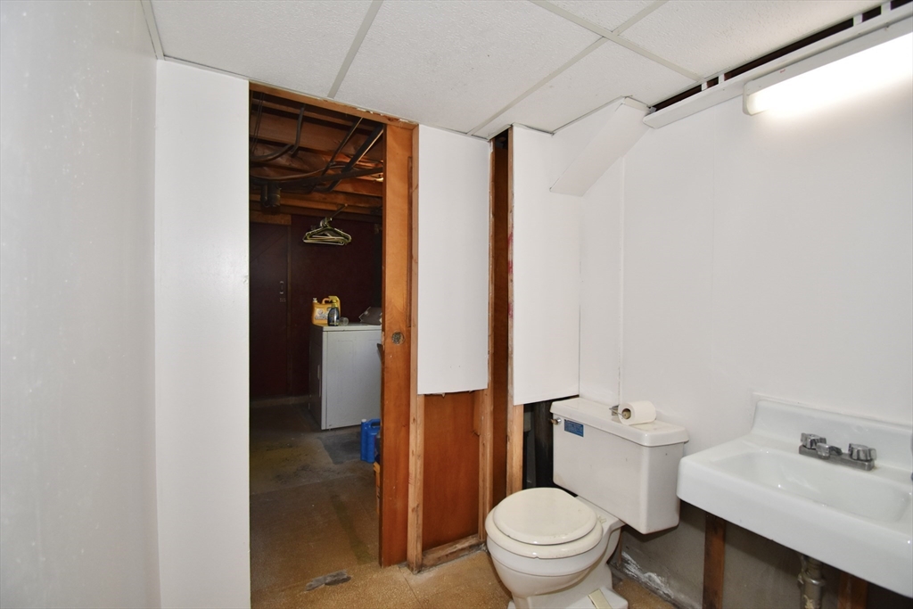 74 Blanche Street Springfield, MA 01119 - Photo 28 of 41 a white toilet sitting next to a bathroom sink