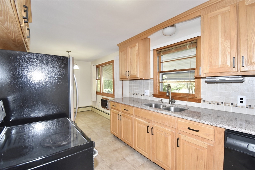 74 Blanche Street Springfield, MA 01119 - Photo 3 of 41 a kitchen with stainless steel appliances a sink stove and cabinets
