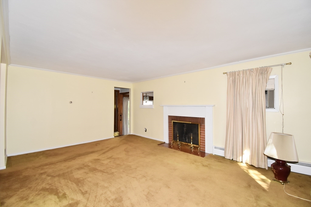 74 Blanche Street Springfield, MA 01119 - Photo 8 of 41 a view of an empty room with wooden floor and a fireplace