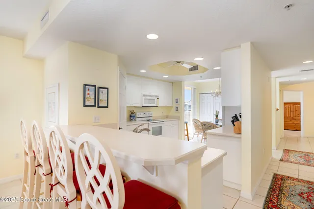 a living room with kitchen island furniture and a view of kitchen