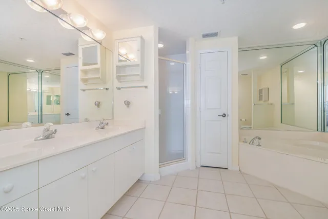 a bathroom with a sink tub shower and a mirror