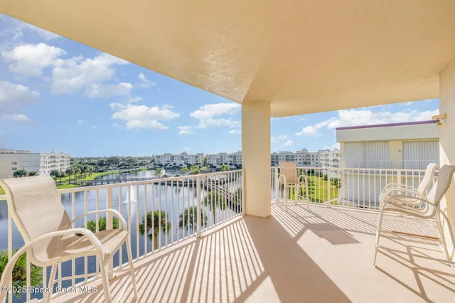 a view of a balcony with lake view and wooden floor