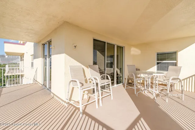 a view of a living room filled with furniture and wooden floor