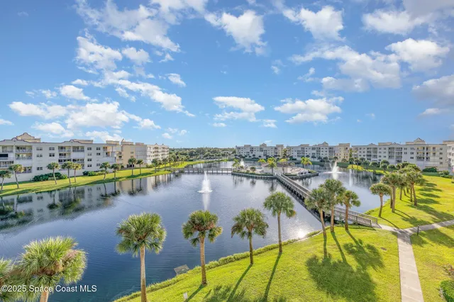 a view of a lake with a houses in the background