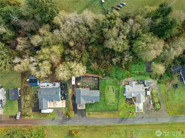 an aerial view of residential houses with outdoor space and swimming pool
