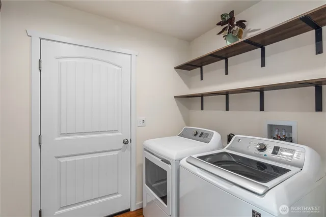 a view of storage and utility room with washer and dryer
