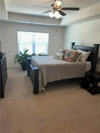 a bed room with a bed and a chandelier